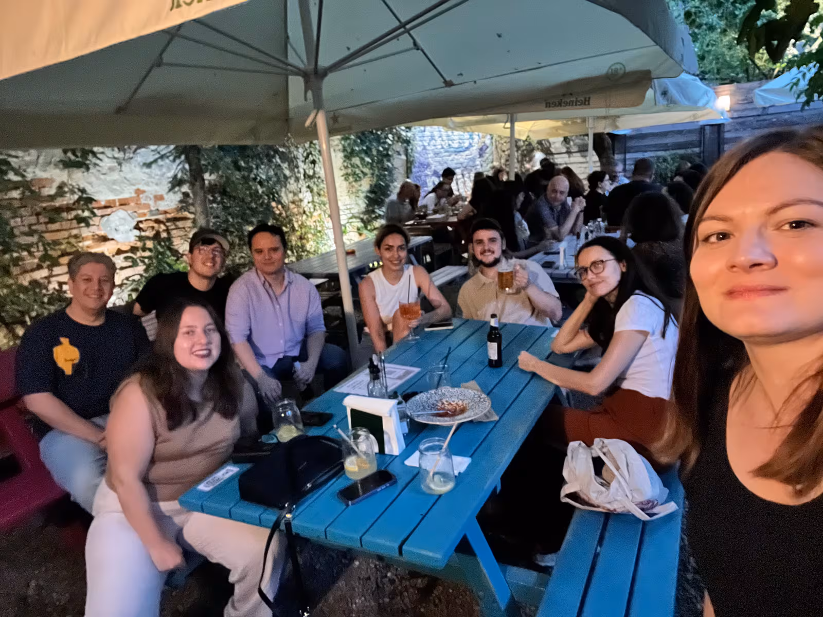 A full picnic table of members at an afternoon meetup in Bucharest