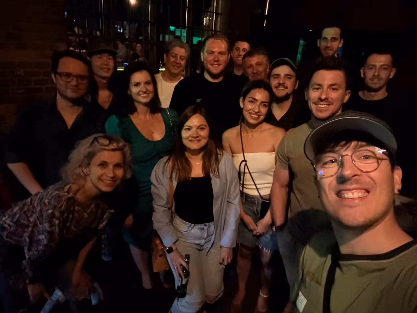 Group photo at an evening meetup in a brick courtyard