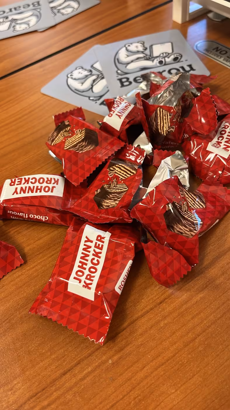 A pile of chocolate wafers on Bearou Coworking coasters