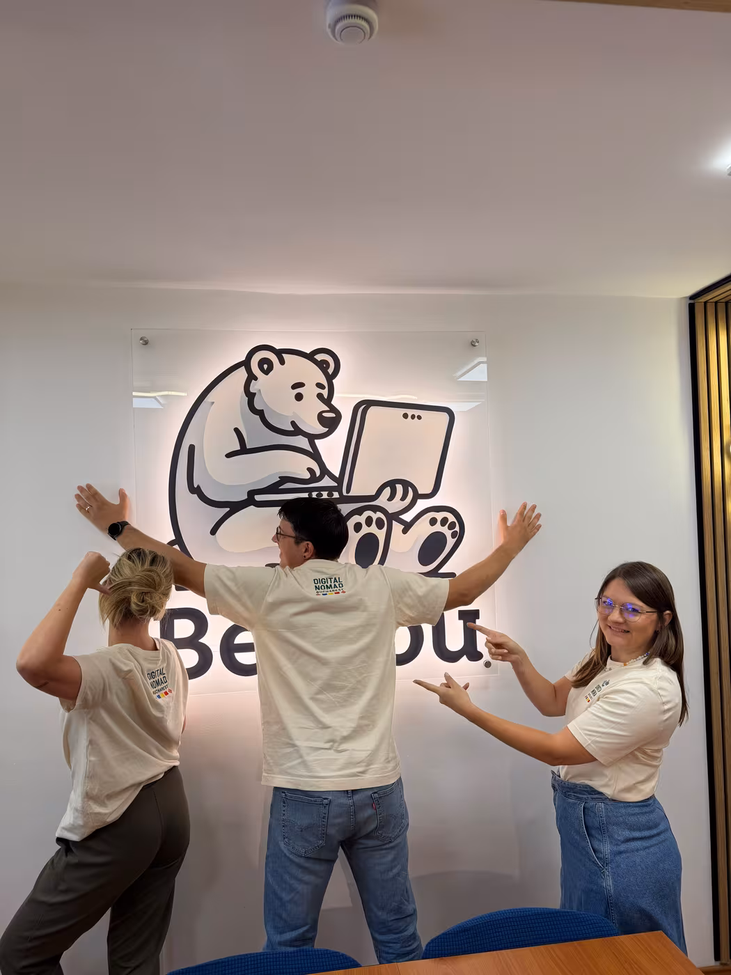 Three members showing the Digital Nomads Bucharest print on the back of their t-shirts