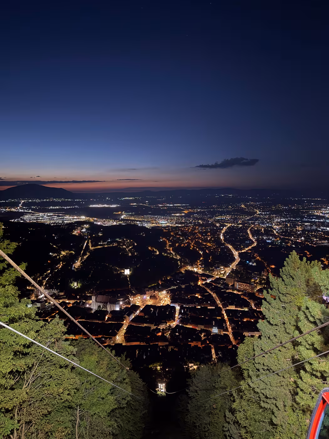 Brașov old town lit up at night, seen from the top of Tâmpa