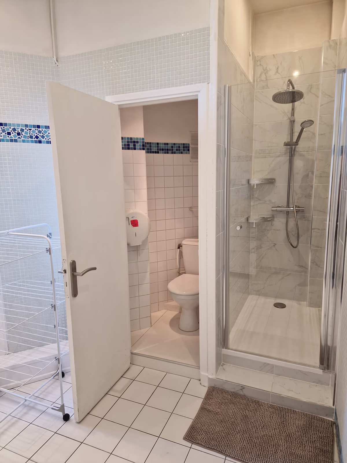 The second bathroom up close, with the glass shower and the door to the separate toilet
