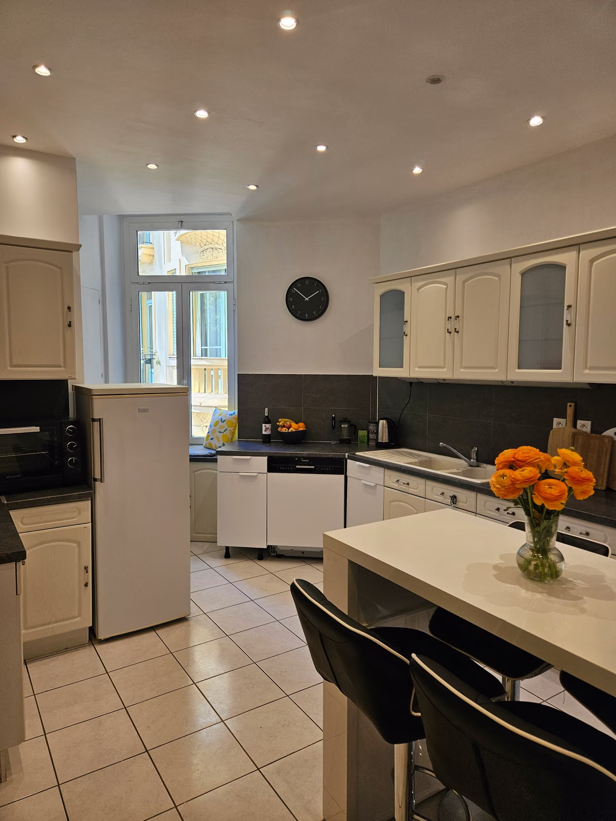 The shared kitchen with a breakfast bar and stools